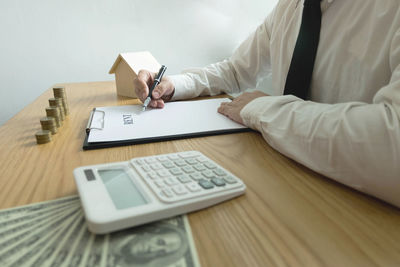 Low angle view of man using mobile phone on table