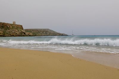 Scenic view of beach against clear sky