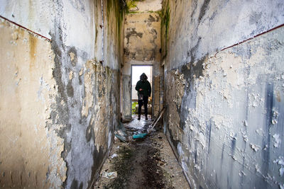 Rear view of man standing in old building