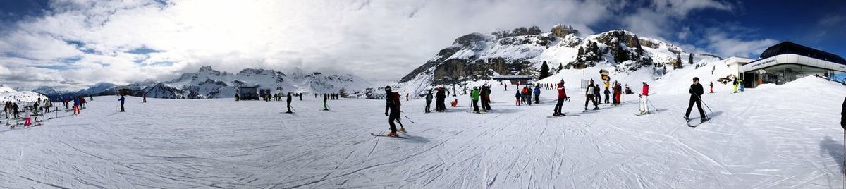 Panoramic view of people skiing on snowcapped mountain