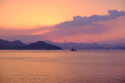 Scenic view of sea against orange sky