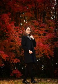 Portrait of young woman standing in autumn