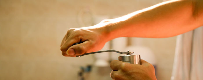 Close-up of hands holding peppermill