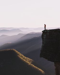 Man standing on the edge of a cliff