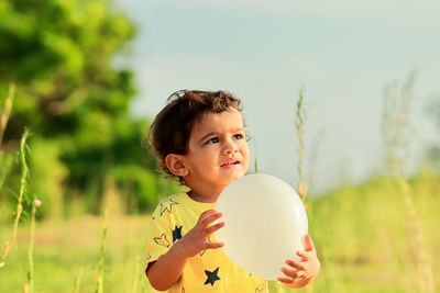 Portrait of happy girl on field