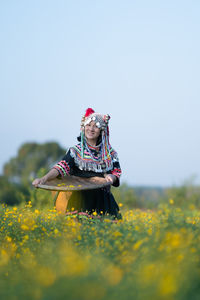 Low angle view of person on grassy field against clear sky