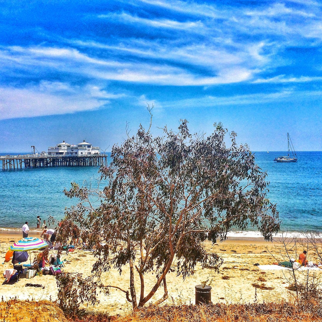 sea, sky, water, beach, horizon over water, cloud - sky, shore, cloud, nature, beauty in nature, blue, tree, tranquility, tranquil scene, scenics, day, cloudy, sand, built structure, incidental people