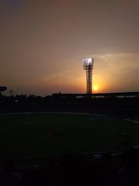 Silhouette of tower against sky during sunset