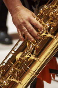 Midsection of man playing guitar