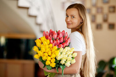 Portrait of a happy girl with a bouquet of multi-colored tulips. women's day, valentine's day, 