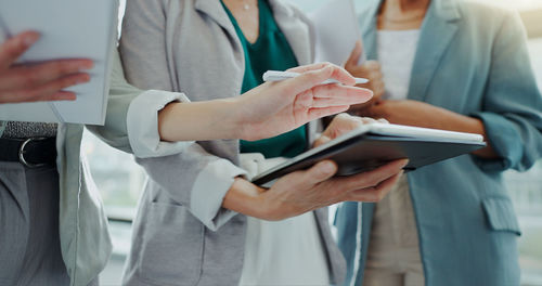 Midsection of businessman using digital tablet