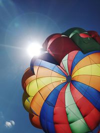 Low angle view of parachute against sky on sunny day