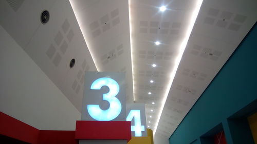 Low angle view of illuminated text on ceiling