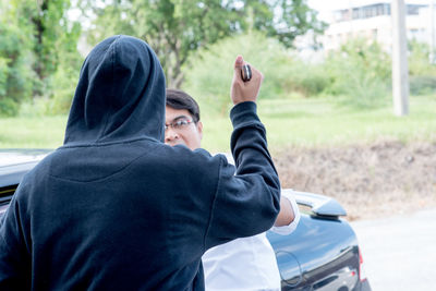 Rear view of man attacking with weapon