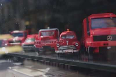 Close-up of wet red road in city