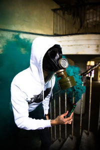 Rear view of person holding umbrella