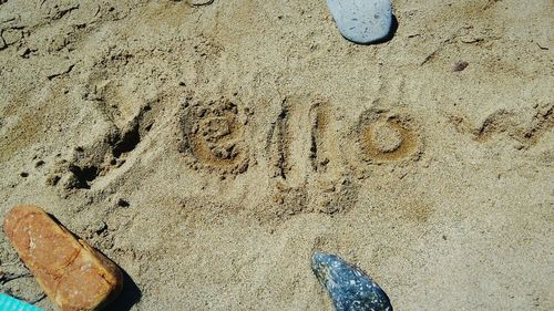 High angle view of text on sand at beach