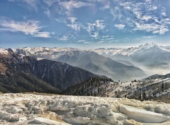 Scenic view of snow covered mountains against sky