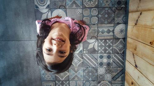 Directly above shot of happy girl standing on floor