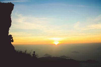 Scenic view of silhouette mountains against sky during sunset