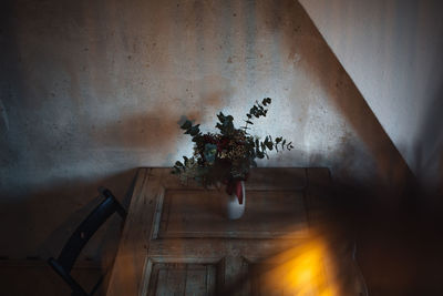 High angle view of vase with bunch of flowers on table