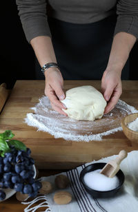 Midsection of woman preparing food on table at home
