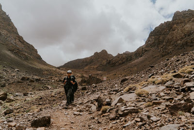 People on mountain against sky