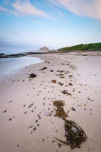 Scenic view of beach against sky, bamburgh northumberland 