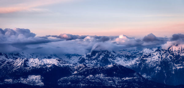 Scenic view of snowcapped mountains against sky during sunset