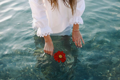 Midsection of woman in water