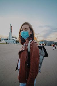 Portrait of woman standing against sky