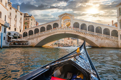 Traditional gondola near world famous canal grande and rialto bridge