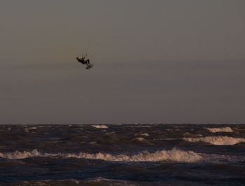 Man kiteboarding over sea