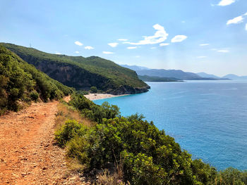 Scenic view of sea and mountains against sky