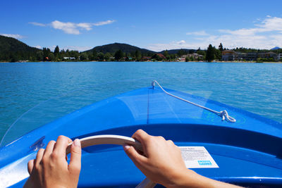 Cropped image of woman steering boat in river