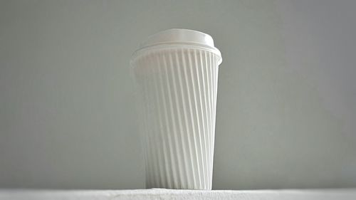 Close up of disposable cup against gray background