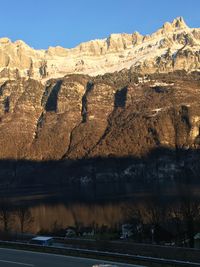 Scenic view of lake by mountain against sky