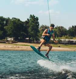 Full length of man wakeboarding in sea