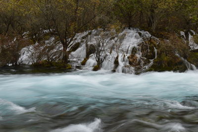 Blurred motion of waterfall and river in forest