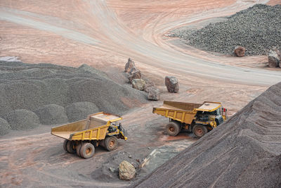 High angle view of dumper trucks at field