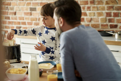 Portrait of cute boy eating food at home