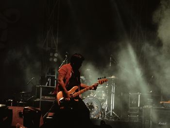 Man playing guitar at music concert