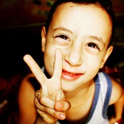 High angle portrait of boy gesturing peace sign