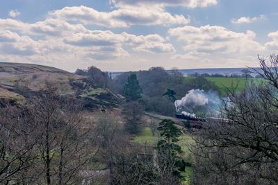 Scenic view of mountains against cloudy sky