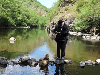 Full length of man standing by lake