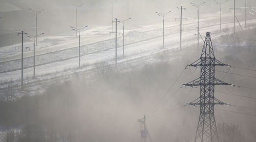 Low angle view of electricity pylon against sky