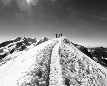 People walking on snow covered mountain