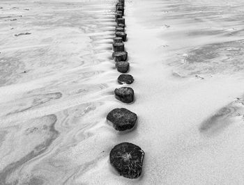 High angle view of footprints on sand at beach