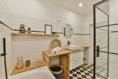 Rear view of woman sitting in bathroom