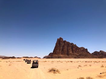 Scenic view of desert against clear blue sky